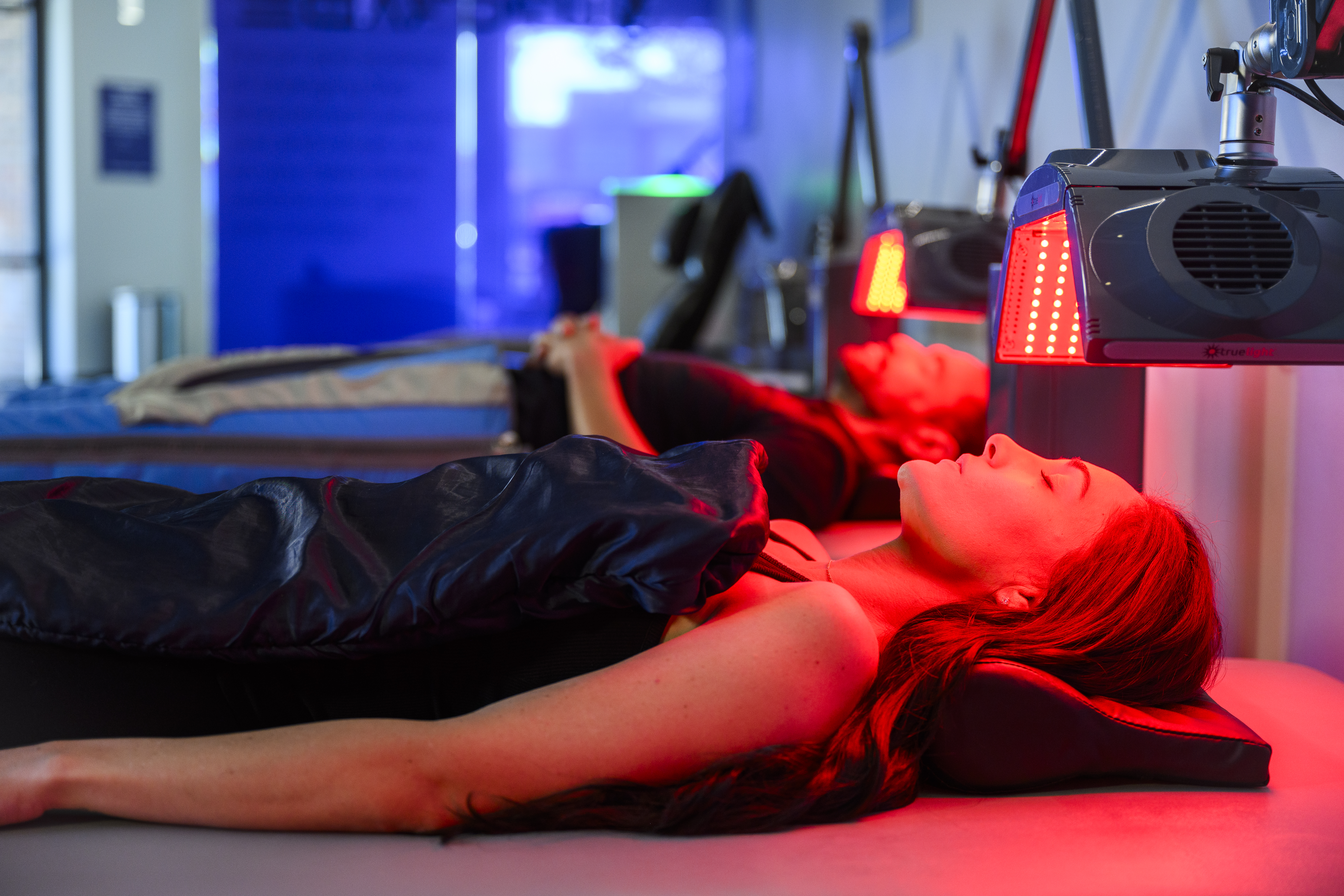 Women lying under a PEMF blanket