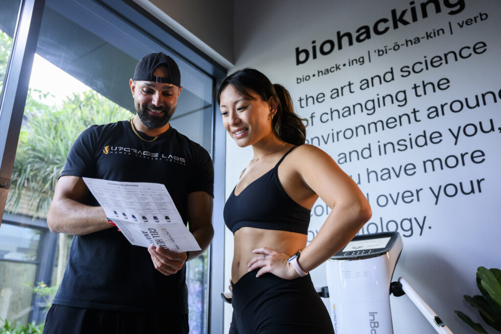 Woman receiving a Cell Health Analysis reading from a staff member at Upgrade Labs