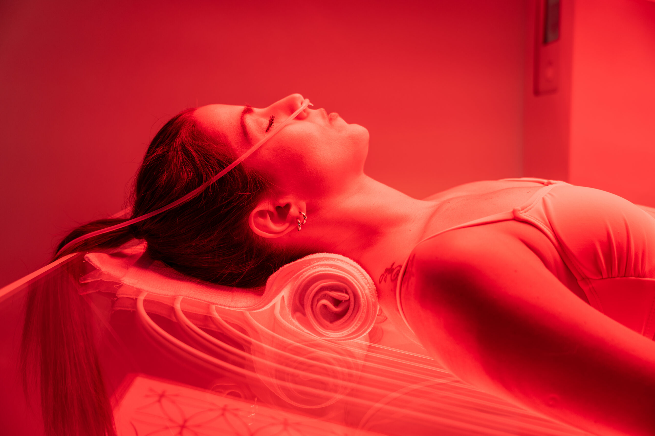 Close-up of a woman lying inside an Ammortal™ recovery chamber.