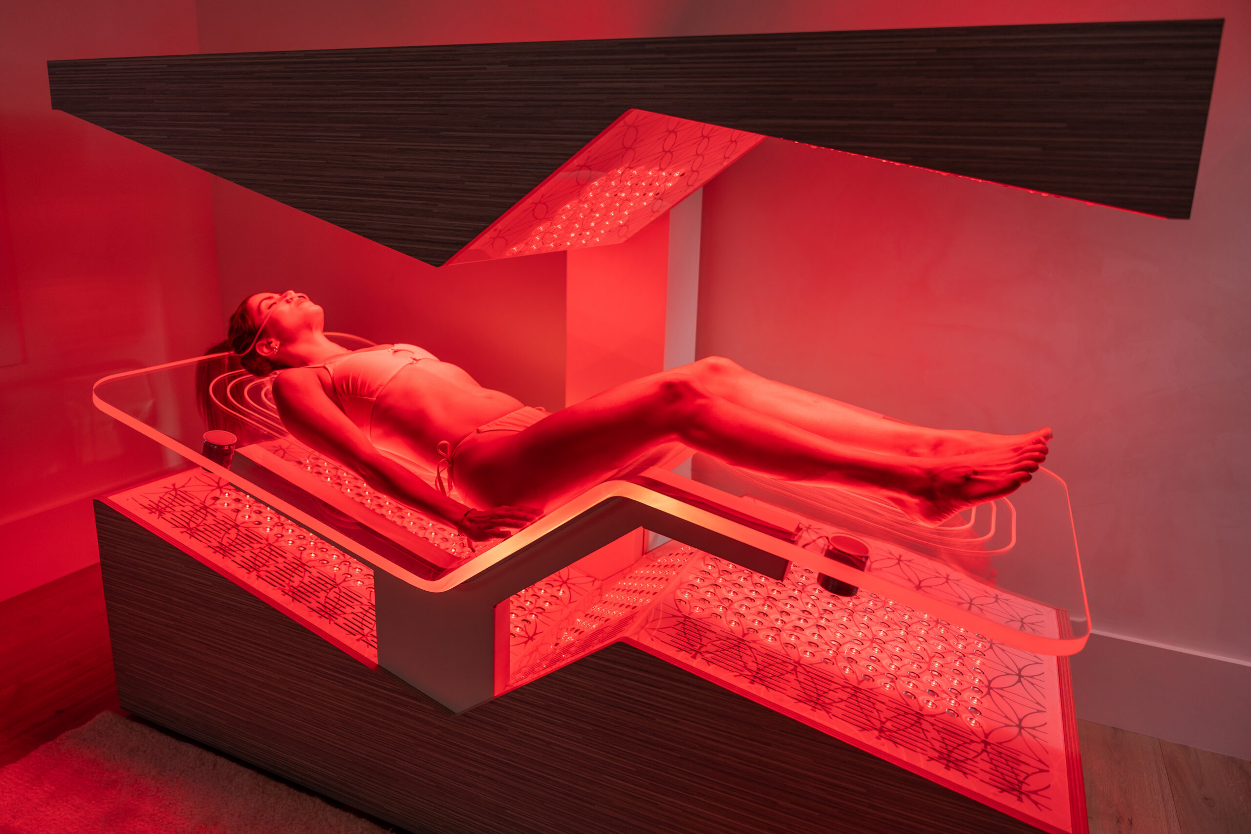 Woman lying on an Ammortal recovery chamber bed
